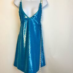 a woman's blue sequin tank top on a mannequin dummy