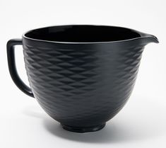 a black ceramic pitcher on a white background