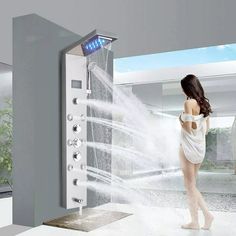 a woman is standing in front of a shower with water coming from the faucet