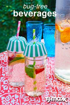 two cups filled with drinks sitting next to each other on a table covered in red and white cloth