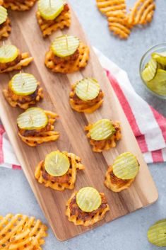 small waffles with pickles and cheese on a cutting board