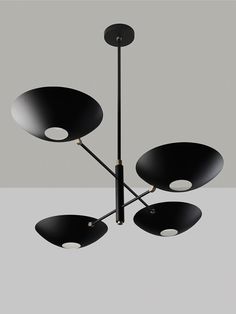 a black chandelier with five lights hanging from it's center and four circular shades