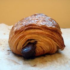 an orange pastry sitting on top of a piece of paper