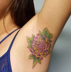 a woman with a flower tattoo on her left arm and right arm behind her back