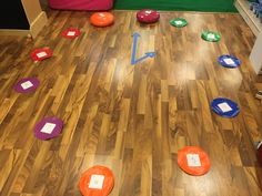 a room with wooden floors and various colored circles on the floor