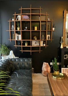 a living room filled with furniture and a wooden shelf next to a mirror on the wall