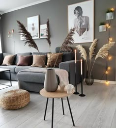 a living room filled with furniture next to a window covered in lights and decor items