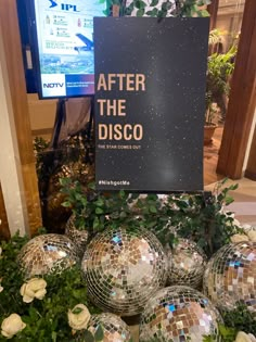 disco balls and greenery are on display in front of a sign that says after the disco