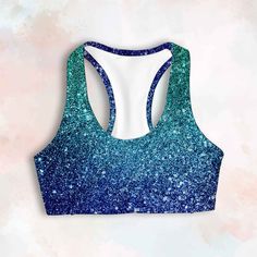 Bling Sports Bra, Shiny Blue Crop Top, Glitter Print Gym Bra D E S C R I P T I O N Designed, printed, and sewn by hand in Miami, FL True to size Seamless Fully lined Elastic band Racerback  Recycled Buttery soft Medium support C A R E & D E T A I L S High-quality 4-way stretch shiny tricot 82% microfiber poly 18% spandex Machine wash warm Hang dry This fabric features a glitter imitation print, offering a shiny and vibrant look. While the sports bra appears bold and gorgeous, please note that it Cheap Blue Sports Bra For Workout, Best Yoga Leggings, Dance Bras, Pineapple Clothes, Festival Crop Tops, Gym Bra, Running Bra, Ocean Drive, Glitter Print