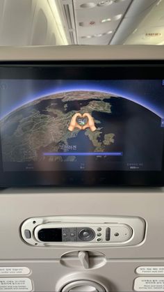 the screen on an airplane showing earth view