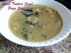 a white bowl filled with soup on top of a table