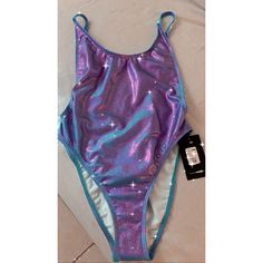 Brand New Fashion Nova Standout Metallic Swimsuit Purple One-piece Party Swimwear, Summer Festival Stretch Leotard, Purple Party Swimwear With Lined Body, Summer Beachwear Party Leotard, Purple Lined Party Swimwear, Poolside Fitted Purple Bodysuit, Purple Sleeveless Party Swimwear, Fitted Purple Bodysuit For Poolside, Stretch Purple Bodysuit For Summer