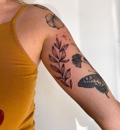 a woman with a tattoo on her arm and butterfly tattoos on the arm, behind her is a yellow tank top