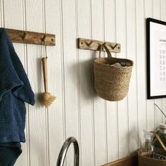 a kitchen sink sitting under two hooks on the wall