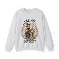 Salem University, Witchy Halloween Crewneck Sweatshirt .: Made with a medium-heavy fabric blend of 50% cotton and 50% polyester (8.0 oz/yd² (271.25 g/m²)), this sweatshirt feels cozy and is the perfect choice for those colder months..: The classic fit along with the crew neckline deliver a comfy wearing experience with a clean-cut style. Meanwhile, the double-needle stitching at the shoulder, armhole, neck, waistband, and cuff seams add top-tier durability. .: Say goodbye to itchiness thanks to Halloween Cotton Sweatshirt With Graphic Print, Halloween Graphic Print Cotton Sweatshirt, Halloween College Cotton Sweatshirt, Halloween College Sweatshirt In Cotton, Halloween Cotton College Sweatshirt, Halloween Cotton Sweatshirt For College, Salem University, Halloween Crewneck Sweatshirt, Granola Girl Aesthetic