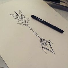 a pen is sitting on top of a piece of paper with a drawing of a feather