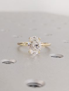 a close up of a diamond ring on a table