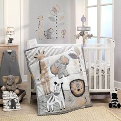 a baby crib bedding set with animals and giraffes