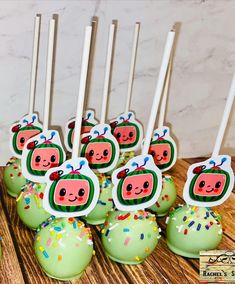 there are many cupcakes with candles in the shape of pigs on them and sprinkles