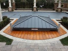 an outdoor swimming pool surrounded by wooden decking