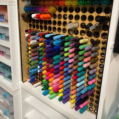 an organized pegboard with lots of markers and pens