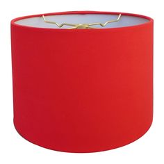 a red lamp shade with a gold ring on it