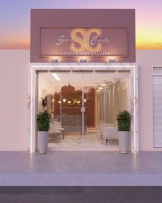 the front entrance to a salon with two potted plants on either side of the door