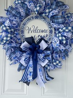 a blue and white wreath with the words welcome on it