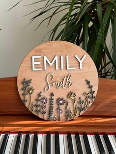 a wooden sign that says,'emly smith'on the side of a piano