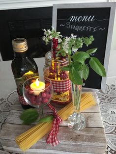 a table topped with jars filled with food and drinks