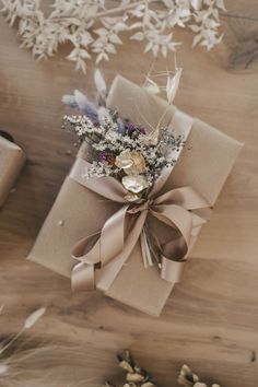 a present wrapped in brown paper with flowers on it