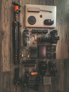 the contents of a camera laid out on a wooden floor