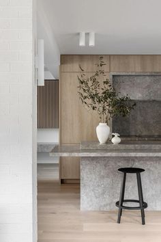 a modern kitchen with an island counter and stools