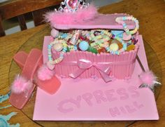 a pink box filled with candy and candies sitting on top of a wooden table