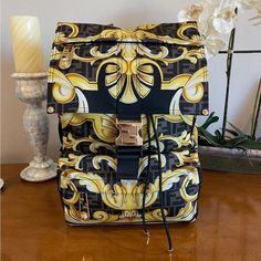 Nwt Fendace Gold Baroque Backpack Printed Medium Bag Condition: Brand New With Tags Seen Through The Eyes Of Donatella Versace, This Fendi By Versace Backpack Features The Fendace Gold Baroque Print - Versace's Barocco Motif Overlapped With Fendi's Monogram Pattern. With A Spacious Drawstring Compartment, The Fold Over Flap Is Detailed With A Ff Buckle, And It's Finished With A Breathable Mesh Padding At The Back For Added Support. Versace's Safety Pin Hardware Is Reinterpreted With Fendi’s O'lo Fendi X Versace, Versace Backpack, Baroque Print, Gold Baroque, Medium Bag, Monogram Pattern, Donatella Versace, The Fold, Medium Bags