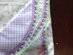 three pieces of cloth with purple and green trim