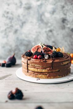 a cake with chocolate frosting and fruit on top