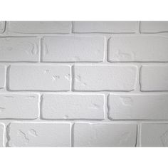 a white brick wall that has been painted to look like it is being used as a background