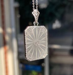 This piece is the most Art Deco statement I have ever seen. Set in 14k white gold, this etched camphor glass is encased in delicate filigree work. In the center is a bead set 0.02ct single cut diamond. The diamond has a color and clarity grade H/I and SI2. You can see the etching seems to be radiating from the center where the diamond is. The pendant measures at 3/4x1 ½ inches. The chain measures at 16 inches. This weighs 3.4dwt/5.4g with the chain. These pieces are a set together, but if you desire a different chain, please message for further inquiry. It is a beautiful piece that can be worn with any desired outfit. If you have any questions, do not be afraid to reach out! Exquisite Engraved White Jewelry, Exquisite White Engraved Jewelry, Antique Diamond Intaglio Jewelry, Formal Etched Sterling Silver Jewelry, Exquisite Engraved White Gold Necklace, Exquisite White Polished Jewelry, Hallmarked Platinum Necklace In White, Elegant White Rectangular Jewelry, Silver 14k White Gold Filigree Jewelry