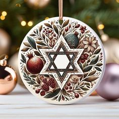 an ornament hanging from a christmas tree next to ornaments and baubles