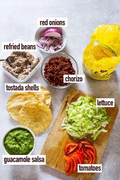 the ingredients to make guacamole on a cutting board