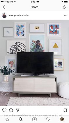 a flat screen tv sitting on top of a wooden entertainment center in a living room