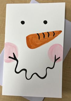 a card with a drawing of a carrot in the shape of a snowman's face