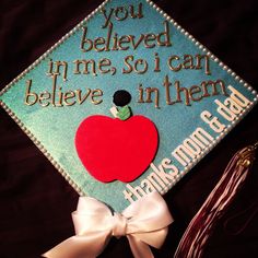 a graduation cap with an apple on it