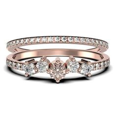 a rose gold engagement ring set with two heart shaped diamonds on the side and an open band