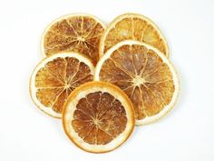 five orange slices cut in half on a white surface