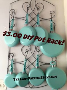 a rack with teal pots and pans hanging from it's sides for $ 3 00