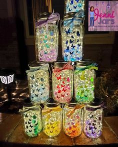 there are many glass jars that have butterflies on them