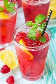 two glasses filled with raspberry lemonade and mint garnish