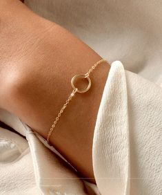 14K Solid Gold Karma Bracelet * Small Ring Bracelet * Delicate Open Circle Bracelet * Eternity Bracelet * Layering Bracelet * Simple PRODUCT DESCRIPTION Our modern everyday Vogue bracelet features a karma circle on a stunning dainty chain. Simple and minimal and the perfect go-to piece. Soft colours and a high quality piece. DETAILS & MATERIALS * Sterling Silver, 14K Gold Filled, 14K Rose Gold Filled & 14K Solid Gold materials. * 10mm circle. * Circles available in smooth or hand hammered finish Minimalist Accessories Jewellery, Minimal Gold Jewelry, Gold Ideas, Eternity Bracelet, Karma Bracelet, Bracelet Layering